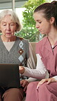 Nursing home, old woman and nurse with laptop, talking and explaining medical schedule on app or web. Healthcare, caregiver and senior person with tech, online and help with telehealth appointment