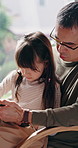 Father, relax and Asian child in home with tablet, play knowledge game and learning for development. Japanese man, daughter an online gaming in living room with tech, bonding or education for growth.