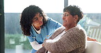 Healthcare, nurse and talking with old woman on sofa in retirement home for assisted living. Checkup, communication and visit with caregiver speaking to senior patient in apartment for service