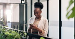 Woman, smile and phone in office with break, sustainable business and text message for go green project. Happy, person and typing in workplace with tech, social media or eco friendly campaign update.