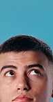 Eyes, thinking and man in studio with space for problem solving, contemplating and decision making. Reflection, planning and person with idea, mindset and perspective vision on blue background