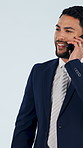 Businessman, consultant or studio with phone call for discussion or negotiation on a blue background. Happy man, employee or sales agent talking with smartphone for business deal or conversation