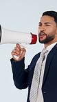 Businessman, shouting and studio with megaphone for announcement on a blue background. Man, sales representative or calling with bullhorn or loudspeaker for bargain deal, sale or business discount