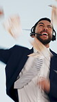 Telemarketer, face and man with headset, success and excited for financial growth and win in studio. Raining, money and happy person with mic, blue background and celebration for lead generation