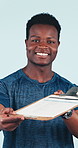 Face, fitness or black man with clipboard for sign up or membership on a blue studio background. Portrait, male person or coach pointing to you with application for registration, health or wellness