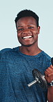 Happy, face or black man with dumbbell in studio for workout exercise on a blue background. Portrait, fitness or male person with smile, strength or bicep curl for weightlifting, health or wellness