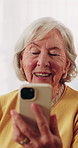 Phone, video call and senior woman on sofa in home for online communication on mobile app. Happy, technology and elderly person in retirement on virtual discussion for contact on website in house.