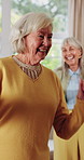 Dancing, friends and senior woman in home with smile, happy moment and bonding fun with rhythm. Connection, movement or elderly person with entertainment, groove together or good time in retirement.
