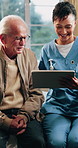 Consulting, nurse or old man in home with tablet, treatment plan or medical record in senior care. Happy, caregiver or elderly person with tech, patient diagnosis or health assessment in retirement.
