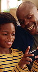 Black family, phone and gaming on sofa with father, son and bonding or happy in home living room. Mobile game, love and smile on couch with parent, dad and child for online app and challenge together
