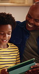 Dad, son and tablet on sofa for elearning, bonding and educational app in home. Black family, man and child with tech for streaming subscription, growth and online development for boy in lounge