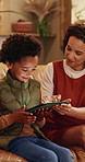 Mother, son and tablet on sofa for elearning, bonding and educational app in home. African family, woman and child with tech for streaming subscription, growth and online development for boy in house