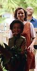 Family, children and moving in new home with box for relocation, fresh start or mortgage together. Mom, dad and walking with happy kids, plant or package for property, shelter or commute in building