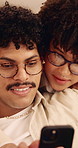 Couple, discussion and chill in house with phone, bonding together and help to download mobile app. People, dating and conversation in home with tech, social media update and internet connectivity.