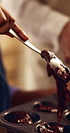 Hands, baking and child with parent in kitchen, learning and culinary skills for dessert preparation. Teaching, recipe and family with cupcake dough, cooking together and person with kid in house