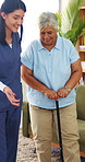 Nurse, senior and happy woman with cane in retirement home for assisted living or support. Caregiver, healthcare worker or helping person with a disability for elderly care or mobility in house