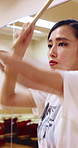 Taiko, practice or Asian woman in studio with drum, tradition or audio skill in performance. Percussion, rehearsal or person with instrument, sound control or music training in Japanese culture.