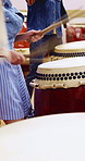 Taiko, performance or hands in class with drums, traditional activity or audio coordination in band practice. Percussion, beat or people with instrument, synchrony rehearsal or music lesson in Japan.