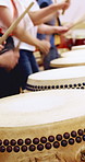 People, hands and drums with lesson in class for music production, sound or taiko tradition. Group, instrument and playing with sticks for percussion rhythm, culture or musical audition together