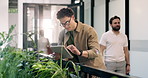 Man, typing and tablet in office with sustainability audit, problem solving or review carbon footprint. Flare, person thinking and tech in business with glasses, environmental impact report and plan.
