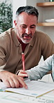 Dad, kid and learning with book in home school for development, talking or study together. Girl, parent and help for education with writing, teaching knowledge and homework assistance with smile