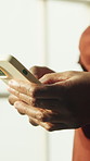 Woman, hands and typing in apartment with phone, text message notification and browsing social media. Person, internet connection and tech in house with mobile app, digital communication and website.
