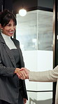 Happy, meeting and business people with handshake in office for introduction, partnership or deal. Woman, employees or colleagues shaking hands with smile for b2b, agreement or greeting in workplace