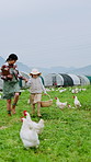 Smile, mother and girl walking on chicken farm for bonding, livestock and basket of eggs. Farmer, parent and daughter holding hands in field with clipboard, agriculture and poultry for agro business