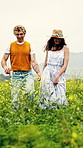 Holiday, walk or couple in field with holding hands, bonding or happy moment on outdoor trip. Laugh, stroll or people with fun, romantic relationship or loving connection on countryside getaway.