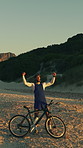 Cycling, success and drone with man in nature for workout goal, training achievement or journey. Celebration, bicycle athlete and mockup space with person and bike outdoor for sand dune and travel
