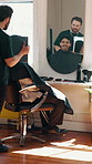 Barber, man and discussion for hairstyle with mirror, smile and customer satisfaction for grooming. Hairdresser, person and talk in salon with reflection, consultation and happy for hair makeover.