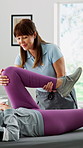 Smile, woman and stretching in office for physio, knee exercise and injury mobility for recovery. Happy, people and physiotherapist for assessment, joint pain and physiotherapy for rehabilitation