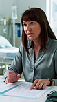 Doctor, woman and consulting with folder in clinic for patient history, health status and questions. Healthcare worker, mature person or medical file for follow up visit, treatment plan and checklist
