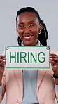Happy, face and black woman with hiring sign for recruiting on a gray studio background. Portrait, female person or employer with smile, billboard or poster for career onboarding, recruitment or job