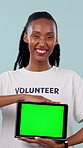 Face, volunteer and black woman with tablet green screen for marketing on a studio background. Portrait, female person or helper with smile or technology display for charity app on mockup space