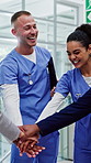 People, doctor or team with hands together in hospital for collaboration, unity or solidarity. Happy group, healthcare workers or employees piling with smile or stack for support or trust in clinic