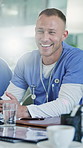 Nurse, hospital and man laughing with team in meeting for funny joke, conversation or discussion. Male person, healthcare worker or group with lens flare in medical conference for humor in boardroom