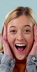 Face, woman and excited in studio with surprise, promotion and announcement for giveaway prize winner. Happy, female person and shock with good news, wow reaction and win reward on blue background.
