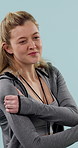 Shoulder pain, fitness and woman in studio with injury, accident or inflammation for exercise. Sports, fatigue and person with hurt arm for muscle sprain, tension or arthritis by blue background.