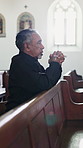 Man, kneeling and prayer in chapel with faith, funeral service and memorial ceremony in religion for death. Mourning, person and thinking of memory for respect, worship and grief in Christian church
