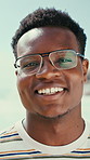 Face, black man and happy at beach for travel, adventure and calm morning on summer holiday. Portrait, male person and laugh at sea for fresh air, positive attitude and tropical vacation for me time