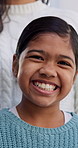 Smile, calm and face of child in home with growth on weekend break, holiday or vacation. Laugh, confident and portrait of girl kid with positive attitude, pride or development in living room at house