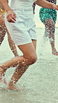 Running, waves and legs of friends on beach for holiday, vacation and bonding on summer weekend. Nature, splash and people by ocean for travel, island adventure and trip for fun, freedom and getaway