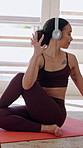 Yoga, woman and online class in apartment with headphones, tablet and virtual guide for stretching. Flexible person, exercise or fitness in home with audio tech, watch video tutorial or spinal twist.