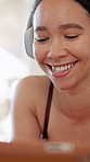 Woman, relax and tablet with headphones for fitness app notification, smile and exercise in home. Happy person, completed workout and rest in house with audio tech, finish video tutorial and lesson.