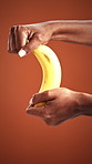 Peeling, health and banana with hands of woman in studio for nutrition, organic fruit and potassium. Wellness, diet and vitamins with person and tropical food on background for fiber and snack