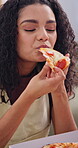 Fast food, eating and pizza with woman in home for Italian takeaway, nutrition and lunch. Bite, happiness and hungry with person and order in living room in house for meal, cuisine and relax