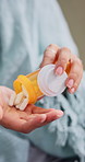 Hands, pills and woman sick in home with healthcare, prescription or antibiotics for virus. Person, bottle or container with medication for chronic illness, medicine or tablets for treatment at house