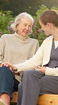 Nurse, old woman and conversation outdoor for comfort, support or advice in healthcare and wellness. Patient, caregiver and happy communication with helping hand, retirement and joke together in park