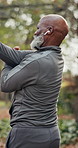 Fitness, stretching and senior man with earphones for health, injury prevention and outdoor. Back warm up, black person or getting ready to exercise, wellness or streaming music in active retirement